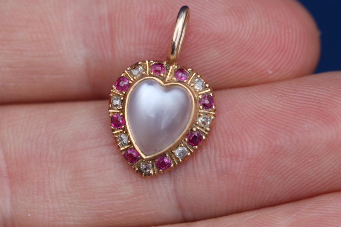Side view showing the domed moonstone and ruby and diamond surround