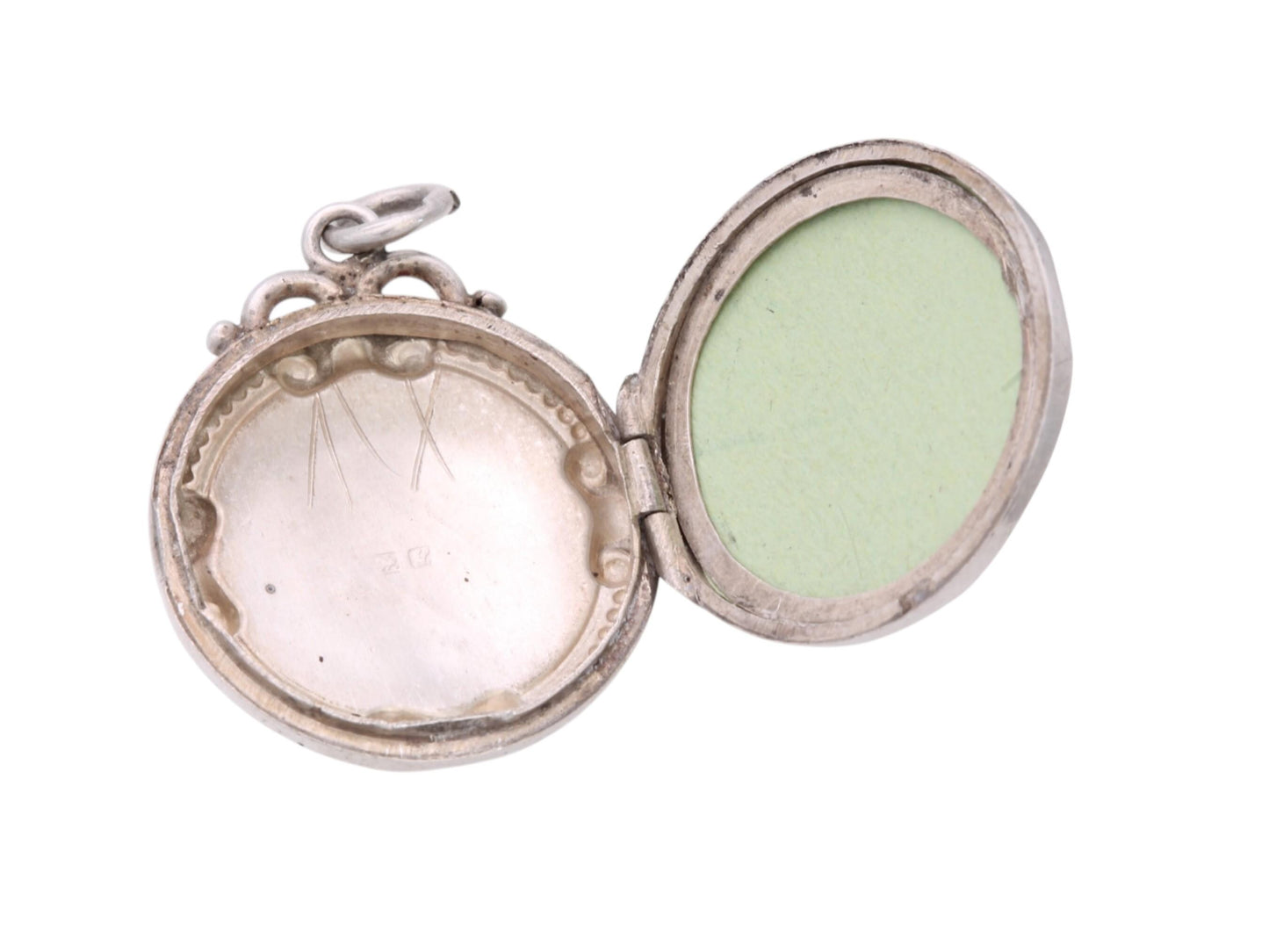 Open Edwardian sterling silver locket showing internal photograph bezel