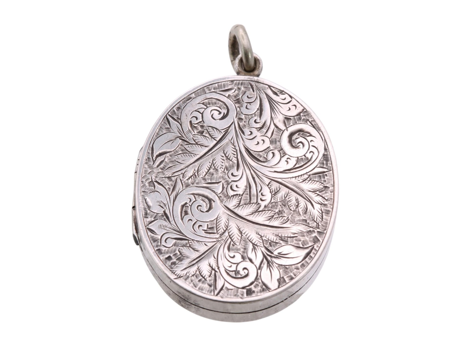 Victorian sterling silver oval locket with engraved scrolling foliate decoration