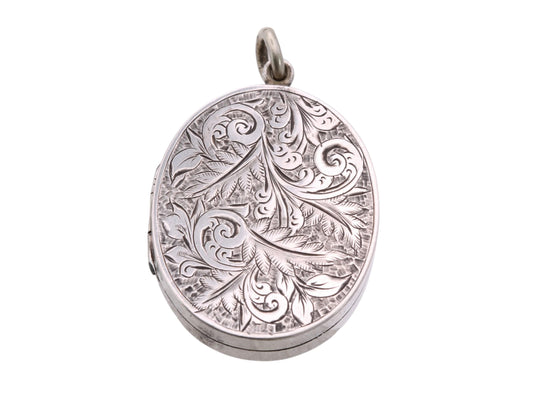 Victorian sterling silver oval locket with engraved scrolling foliate decoration