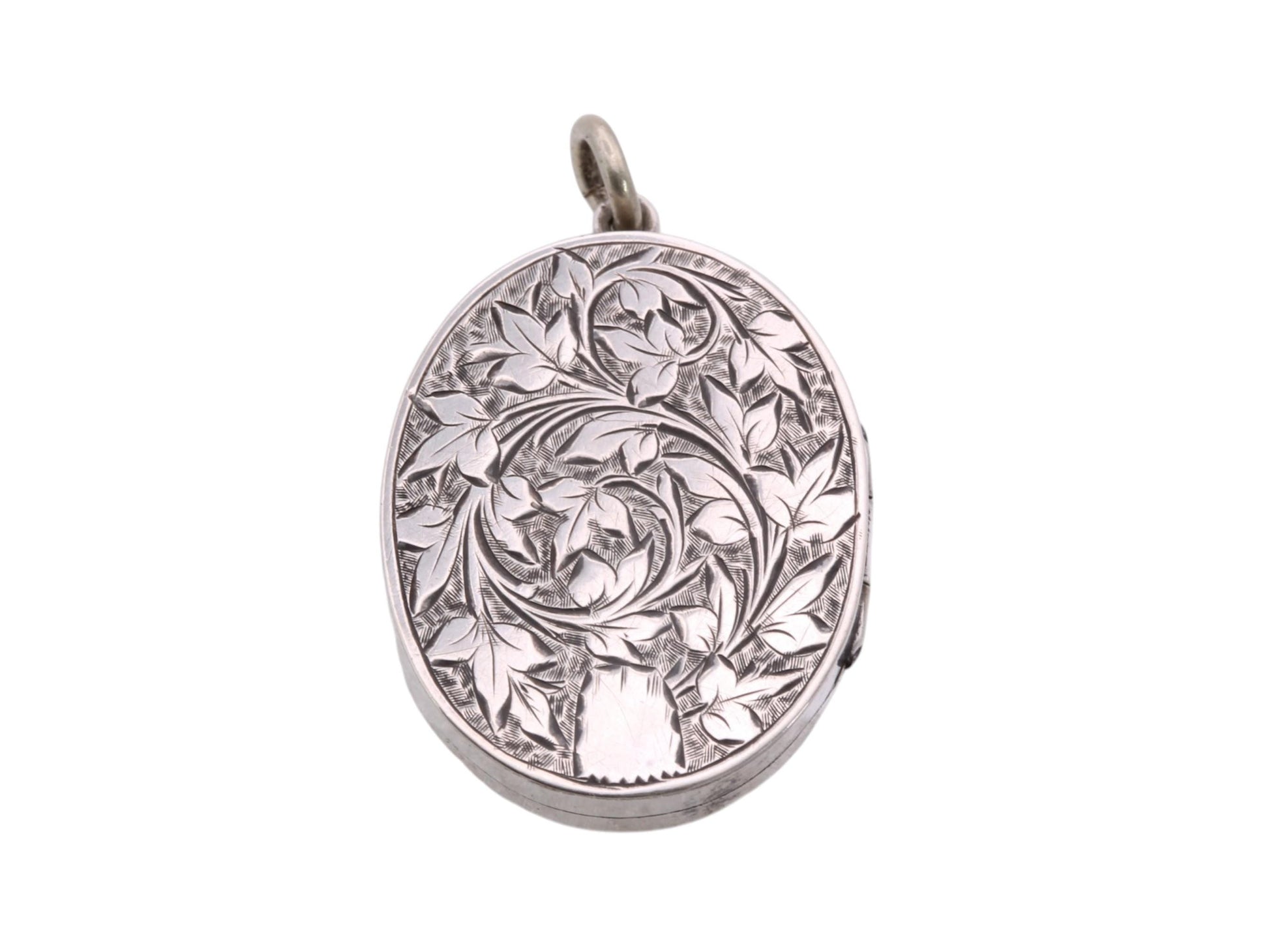 Reverse of Victorian sterling silver locket with hand engraved leaf and scroll decoration