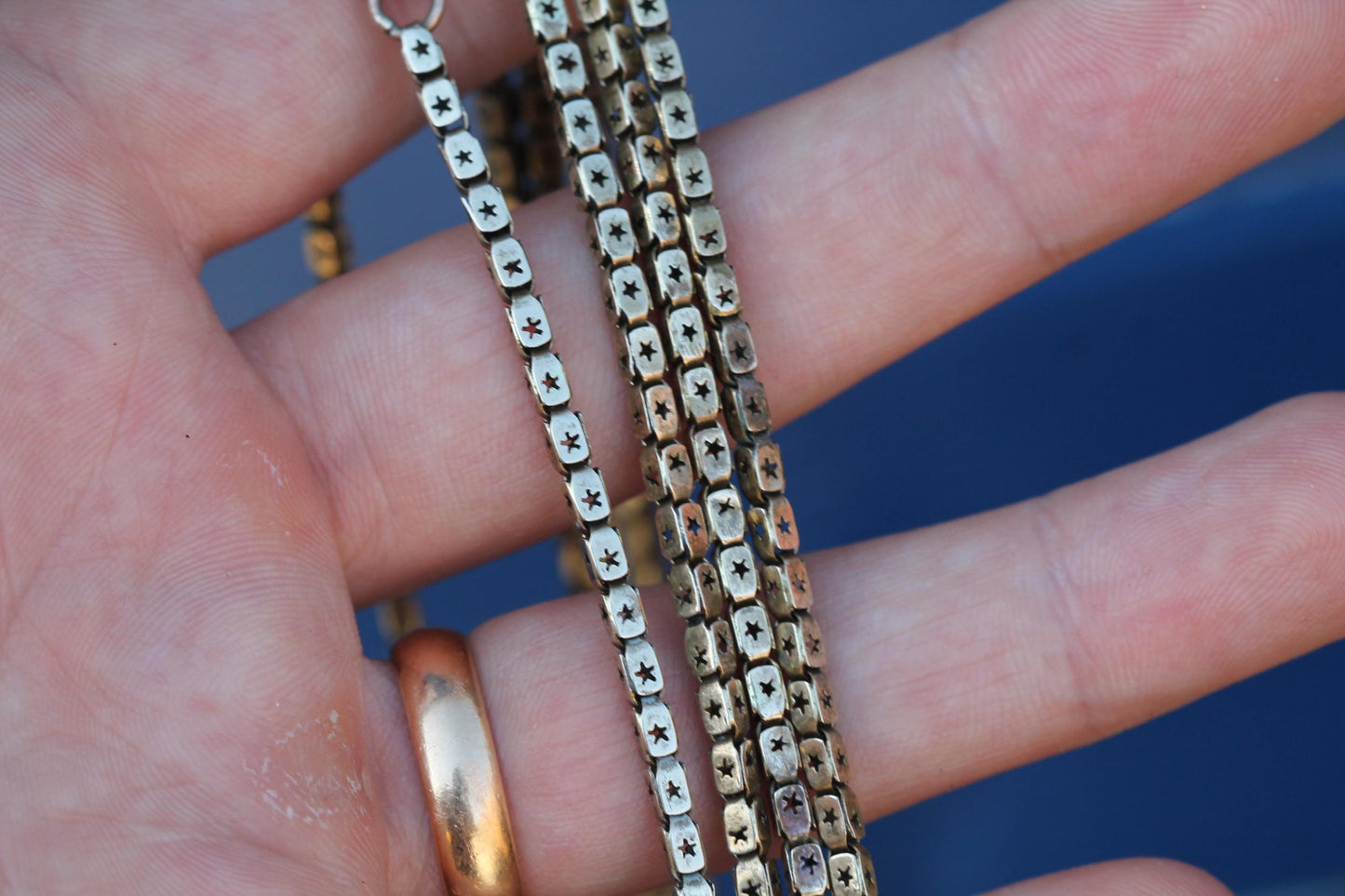 Close-up of Victorian long guard chain showing star pierced links