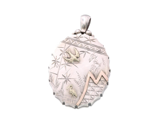 Victorian sterling silver locket with applied gold birds and engraved foliage
