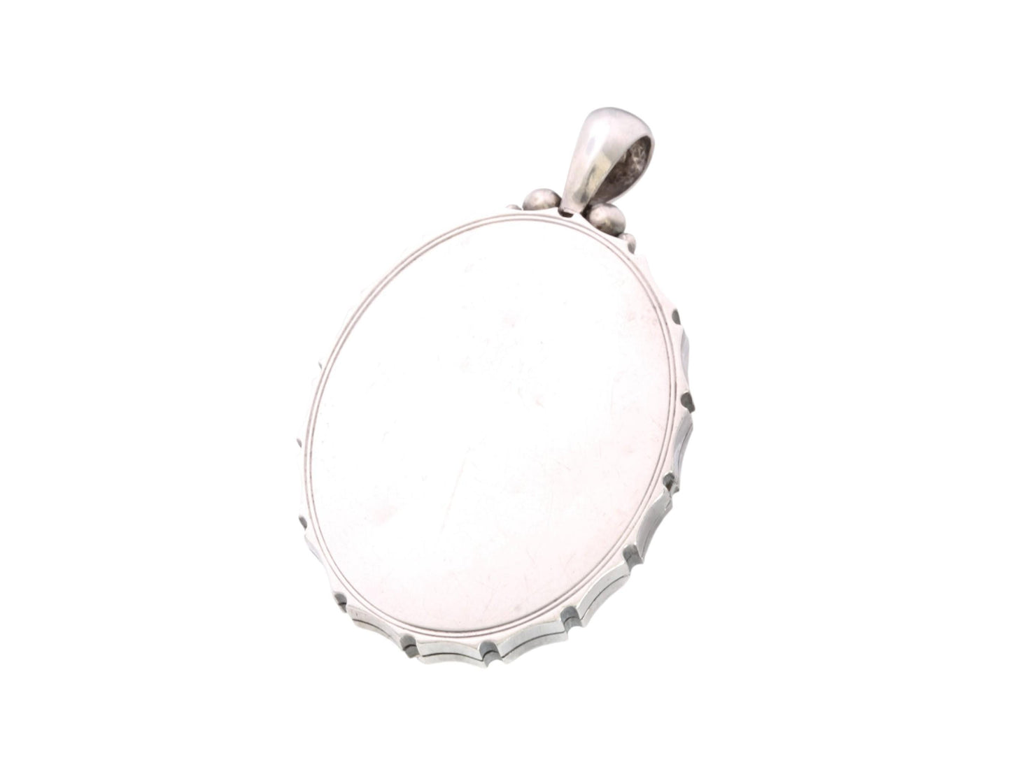 Open antique silver locket showing clear acrylic panel and interior insert