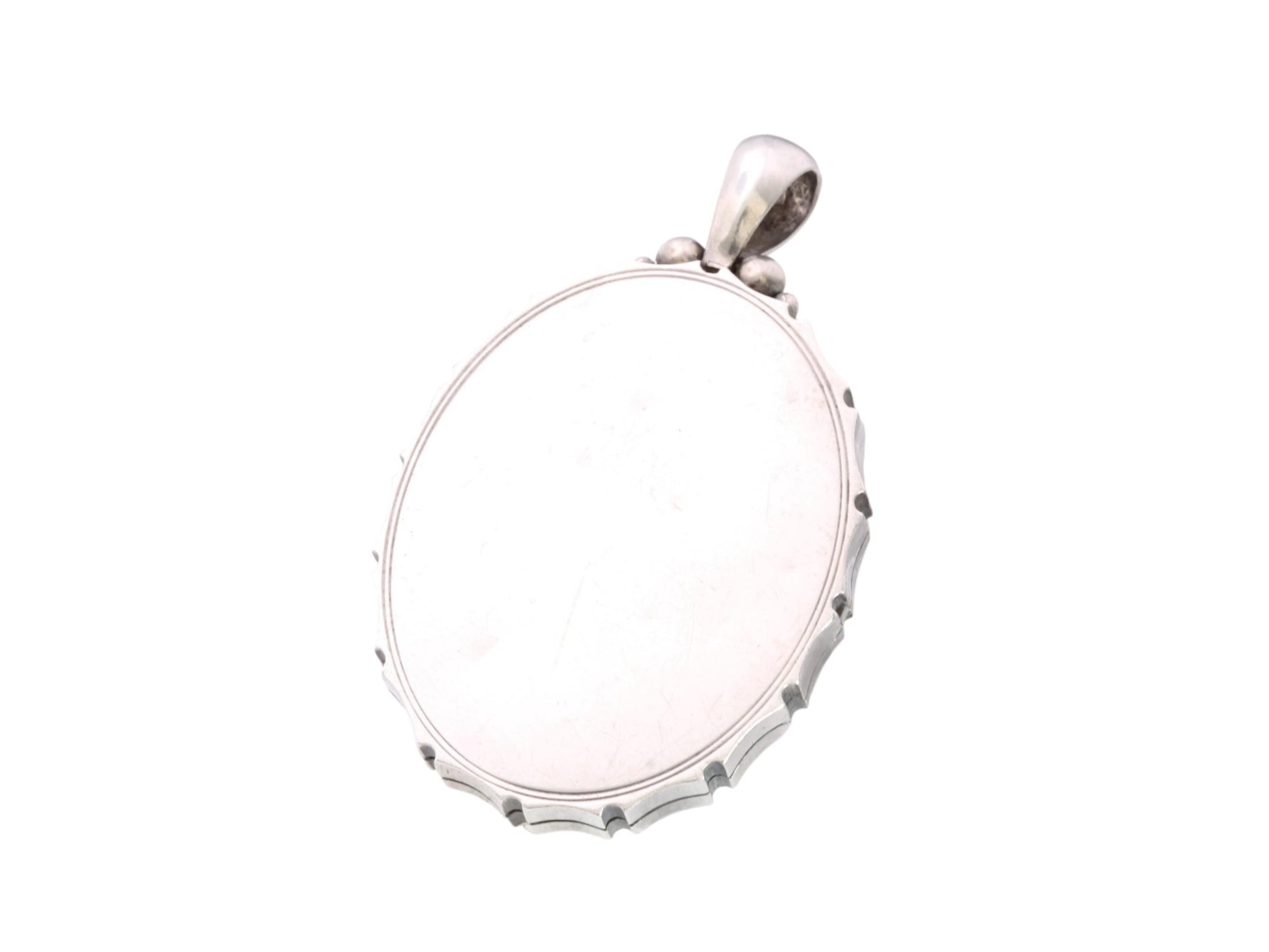 Open antique silver locket showing clear acrylic panel and interior insert
