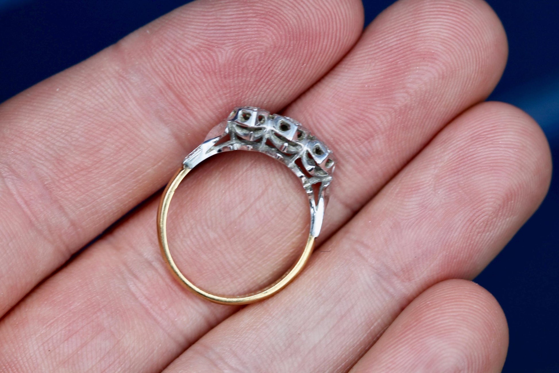 Front view of antique three diamond heart ring in gold and platinum