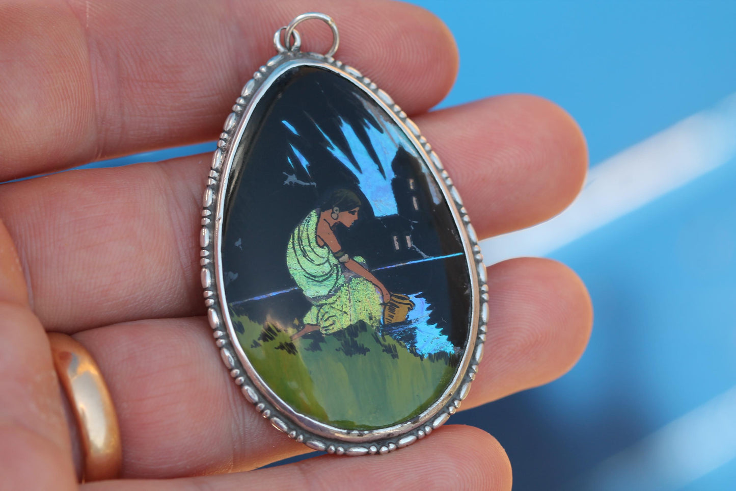 Antique butterfly wing pendant with iridescent blue night scene