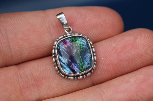 Art Deco sterling silver butterfly wing pendant showing iridescent blue, green and purple wing