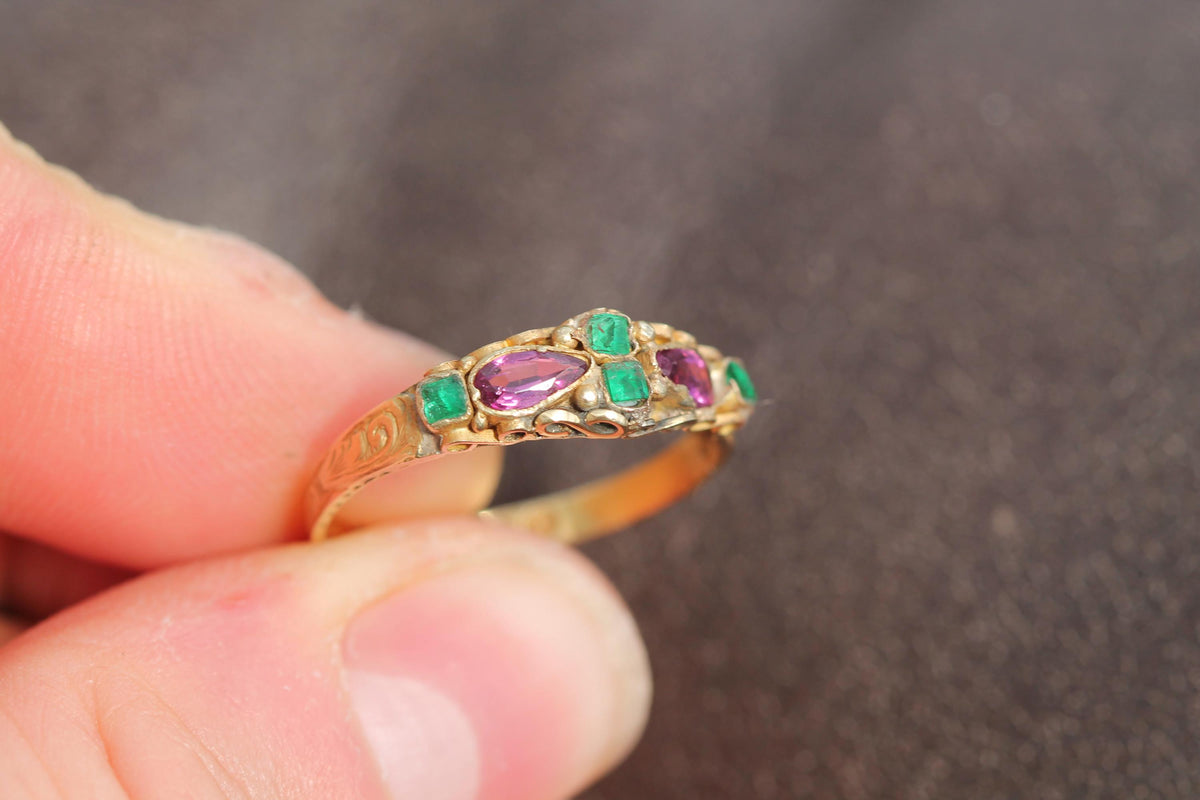 Victorian garnet and emerald ring worn on the finger