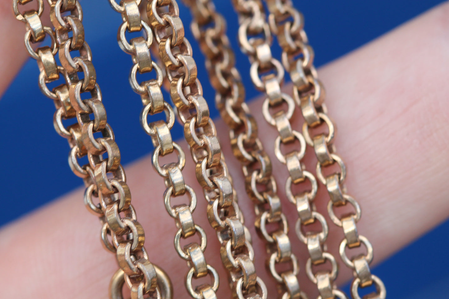 Close-up of antique rolled gold chain showing repeating articulated links