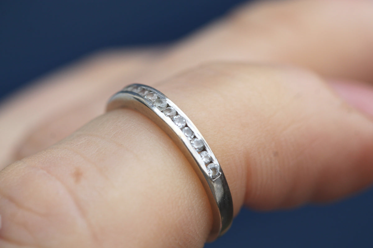 18ct white gold diamond half eternity ring worn on the finger