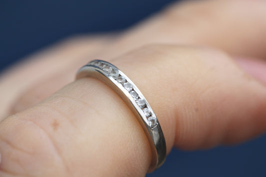 18ct white gold diamond half eternity ring worn on the finger