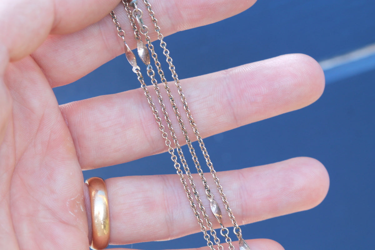 Full view of antique rolled gold swirl link necklace