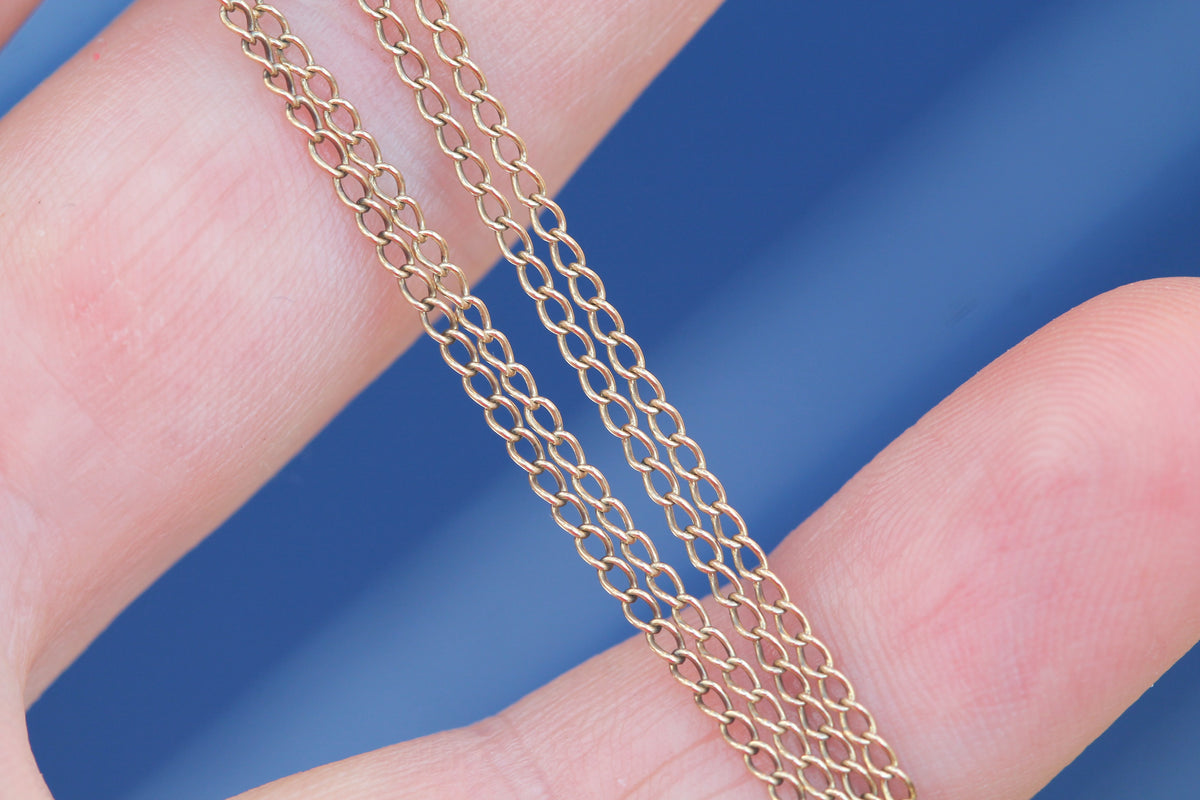 Vintage 9ct gold fine curb link necklace shown across fingers