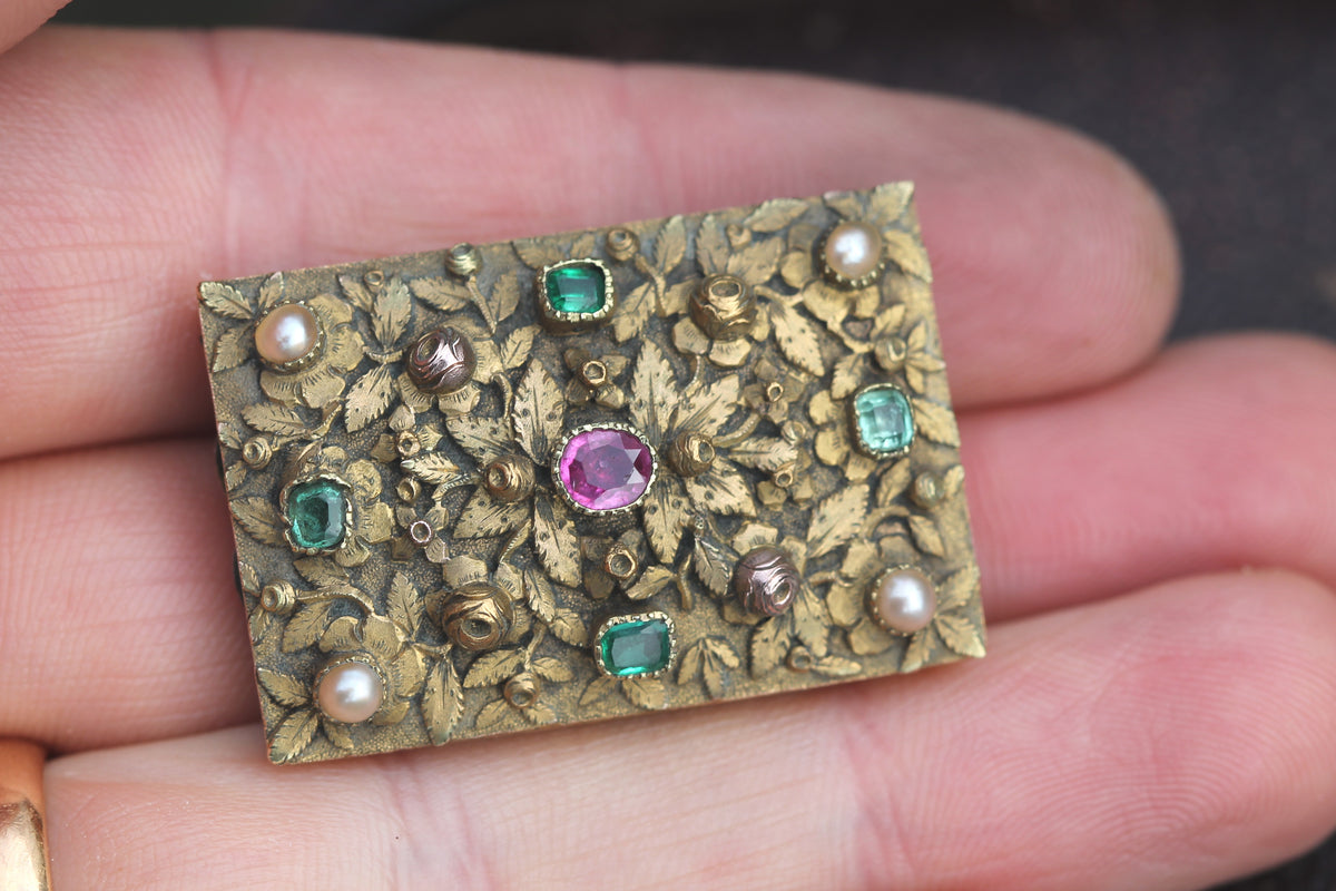 Close-up of late Georgian floral goldwork with ruby emeralds and seed pearls