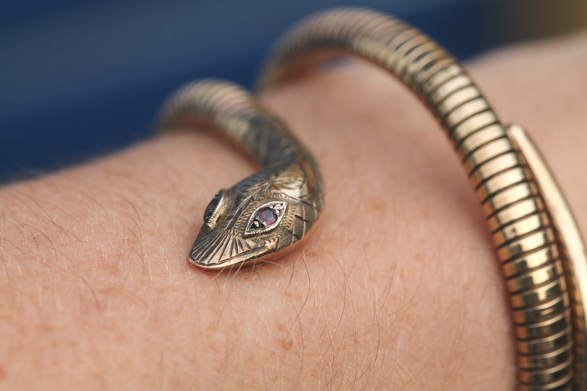 Close-up of engraved snake head with two ruby eyes