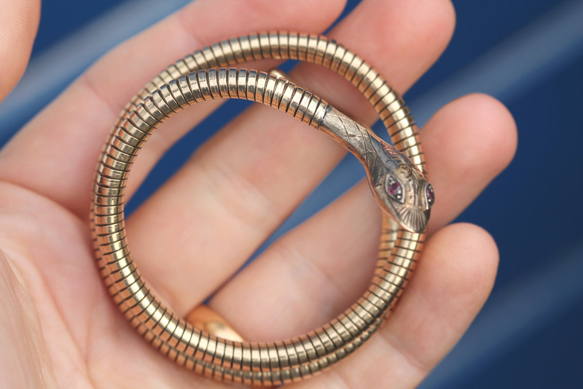 Gold snake bangle worn around the wrist