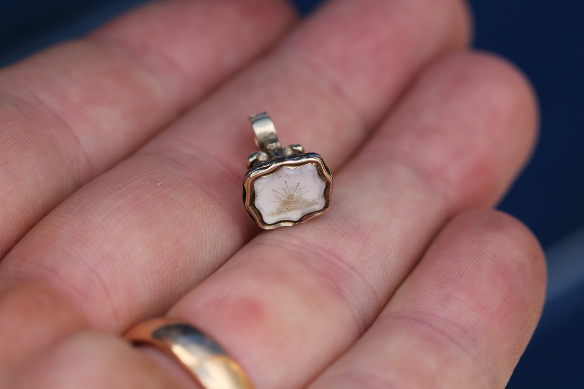 Victorian chalcedony seal pendant shown in the hand