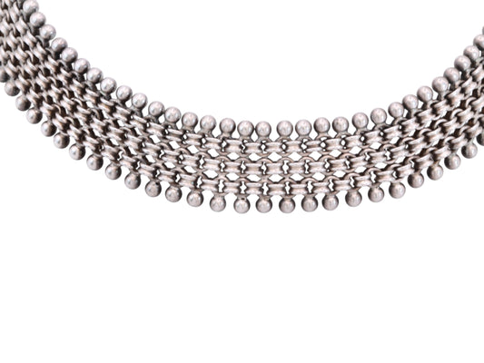 Close-up of antique Victorian sterling silver collar necklace with beaded edging