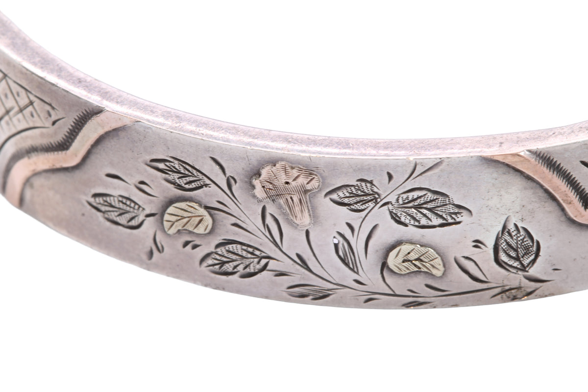 Antique silver and gold Victorian bangle worn on the wrist