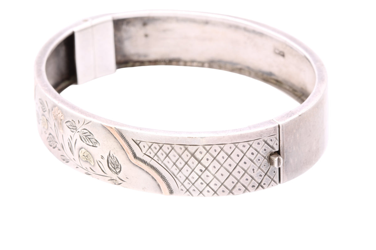 Side view of Victorian silver hinged bangle showing engraved crosshatched panels