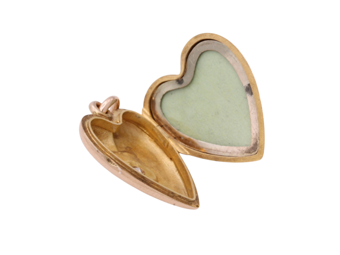 Open antique gold heart locket showing internal keepsake compartment