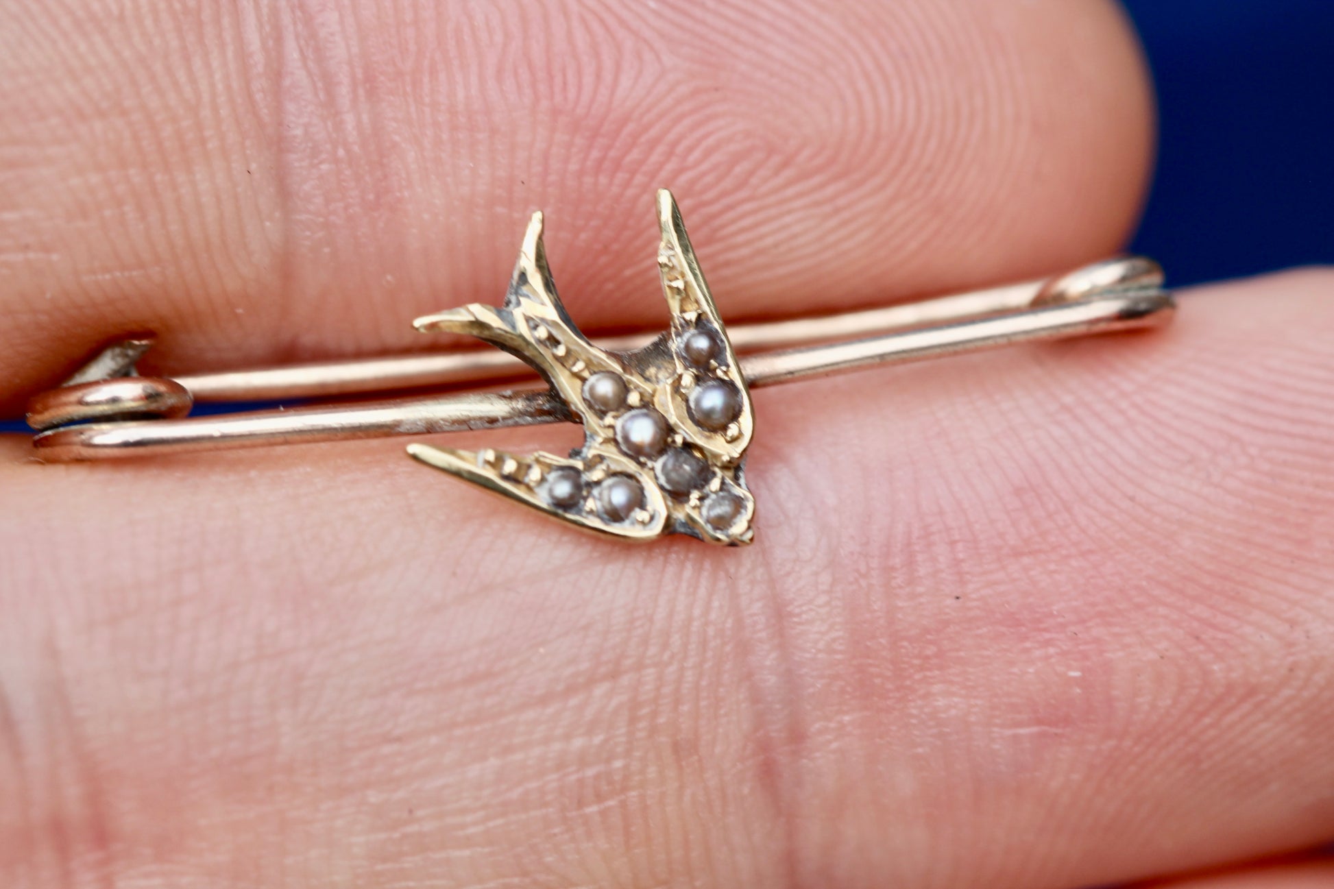 Reverse of Edwardian gold swallow brooch showing safety-pin fitting
