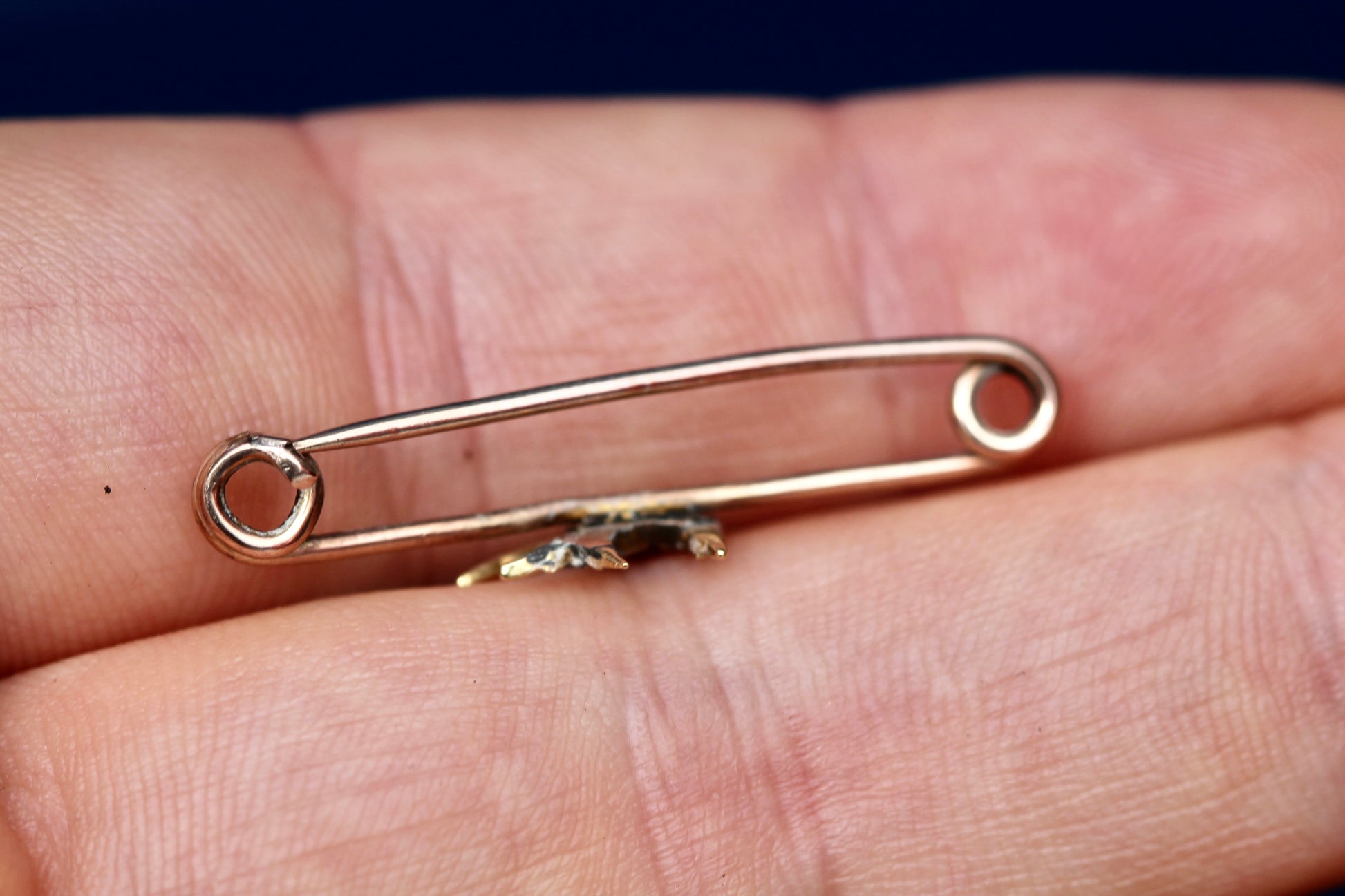 Side view of antique 9ct gold pearl swallow brooch