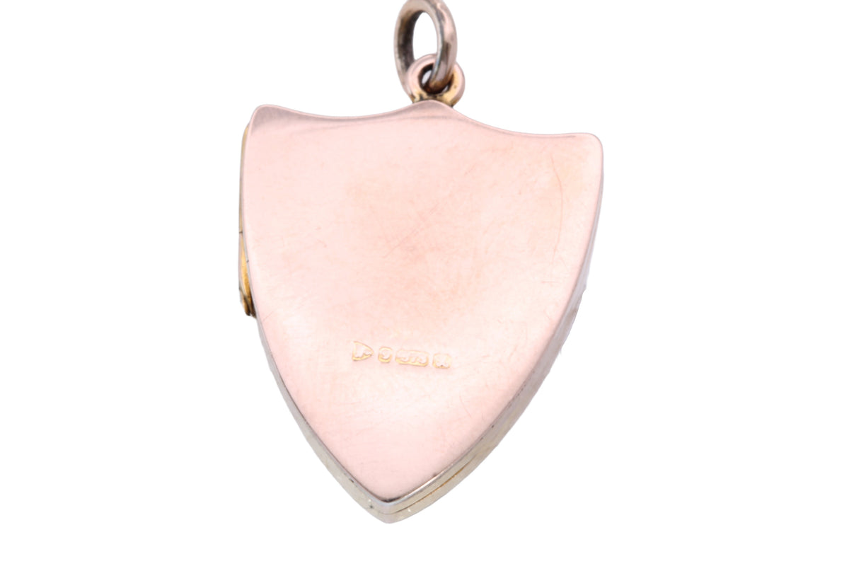Open antique 9ct gold shield locket showing glass and acrylic panels