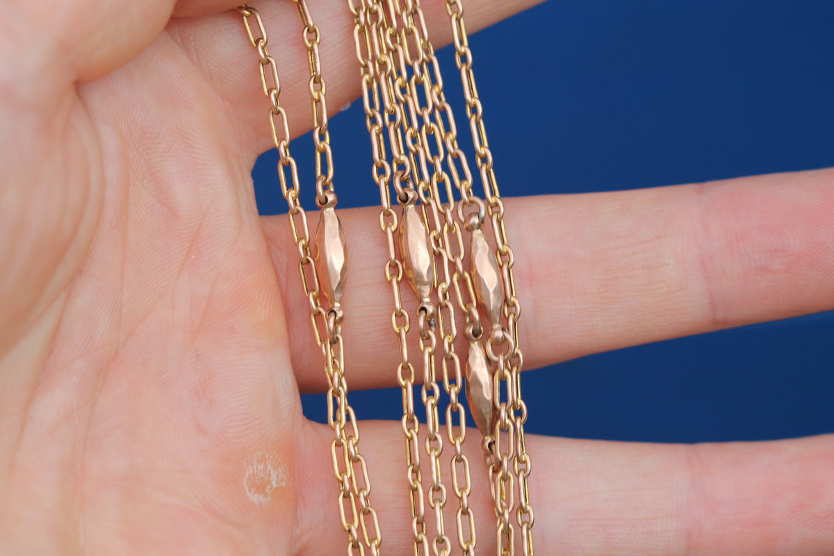 Full view of antique 56 inch 9ct gold trombone link necklace