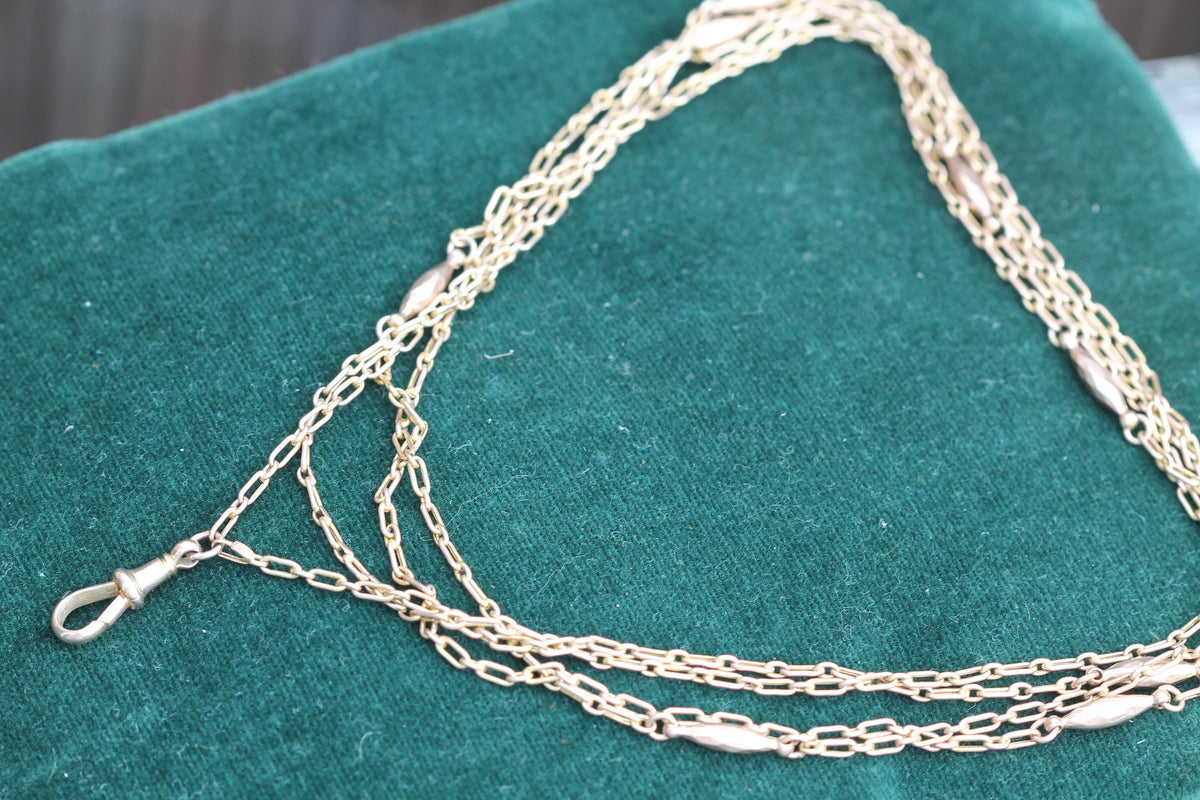 Close-up of 9ct gold trombone links and stamped dog clip