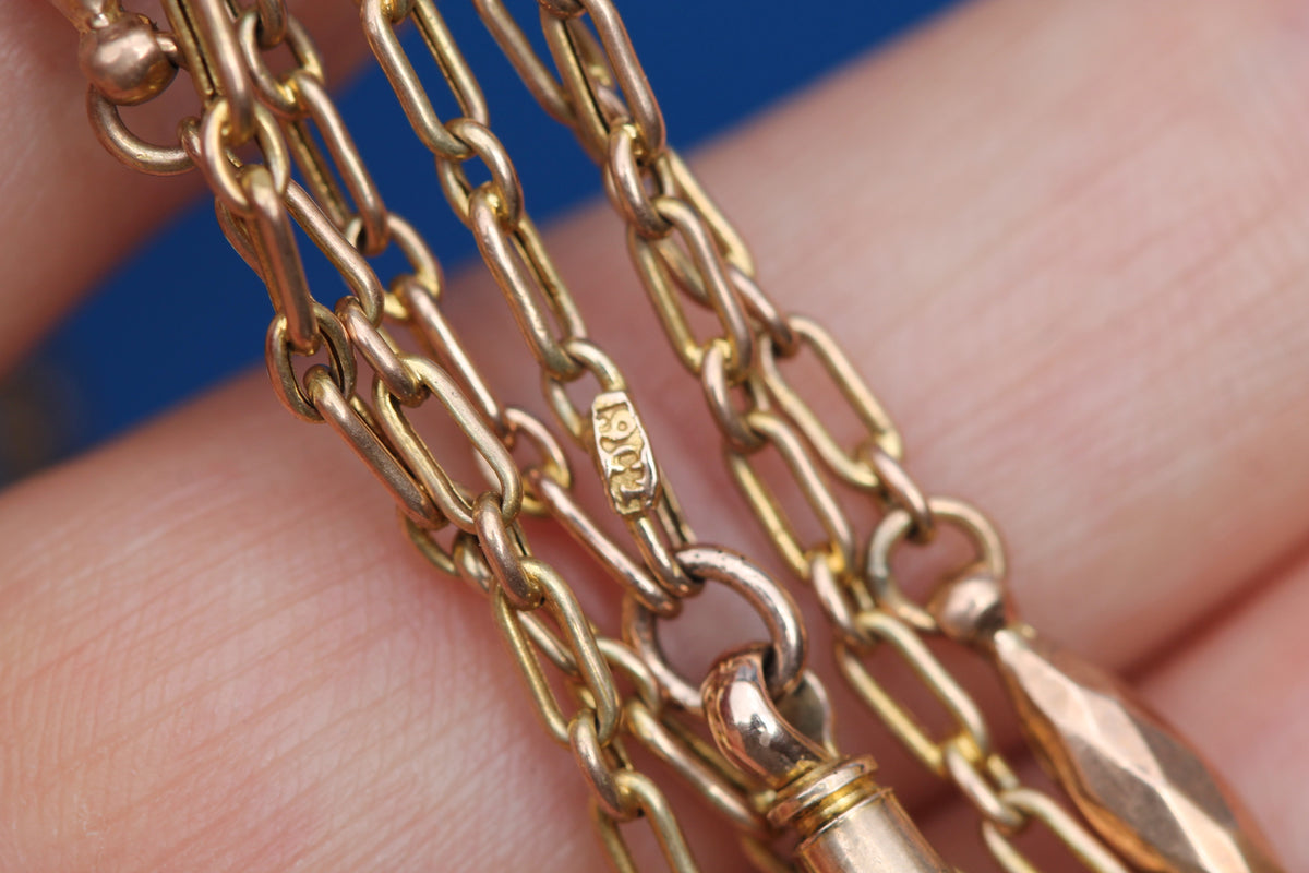 Close-up of faceted tab link on antique 9ct gold long guard chain