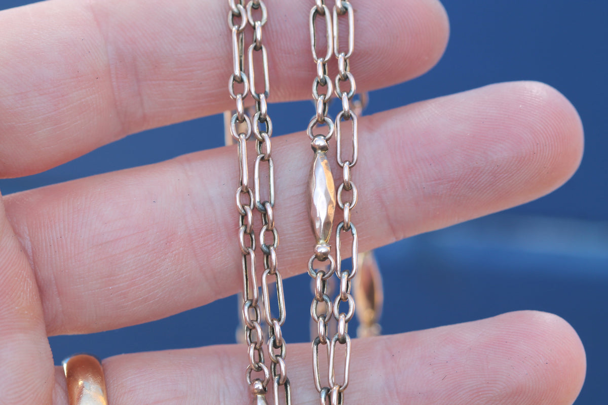 Close-up of alternating trombone and faceted tab links on Victorian gold chain