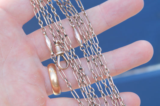 Antique Victorian 9ct rose gold trombone and faceted tab long guard chain