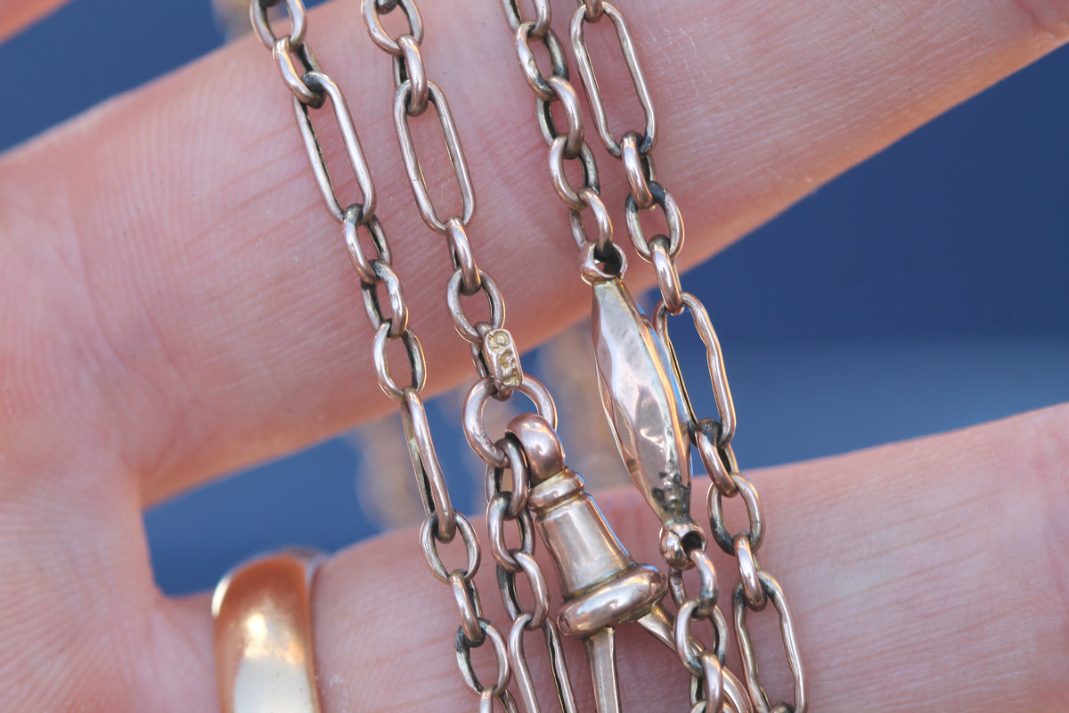 Antique 9ct rose gold long guard showing original dog clip and hallmarks