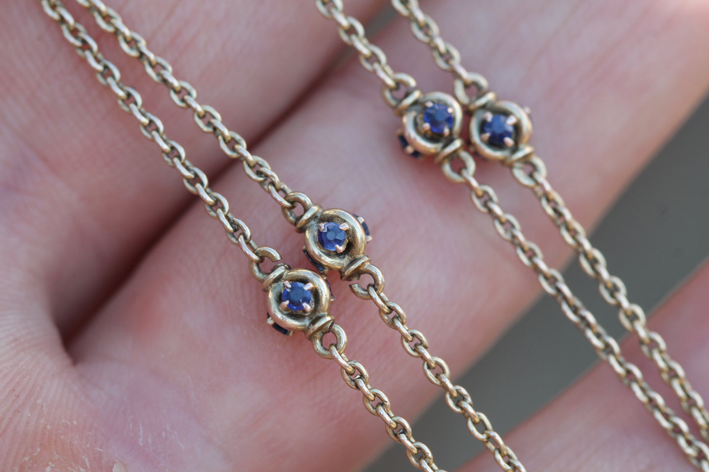 Antique sapphire long guard necklace displayed in a period jewellery box