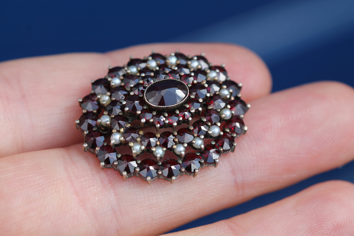 Reverse of vintage garnet brooch showing open-backed silver gilt setting