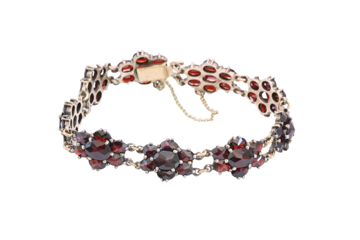Full view of articulated antique garnet bracelet with safety chain