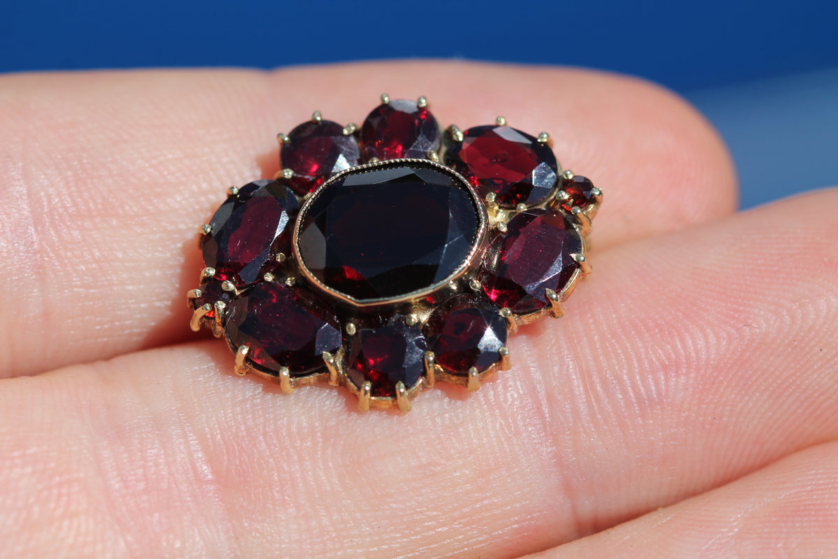 Vintage sterling silver gilt garnet cluster brooch with oval centre stone