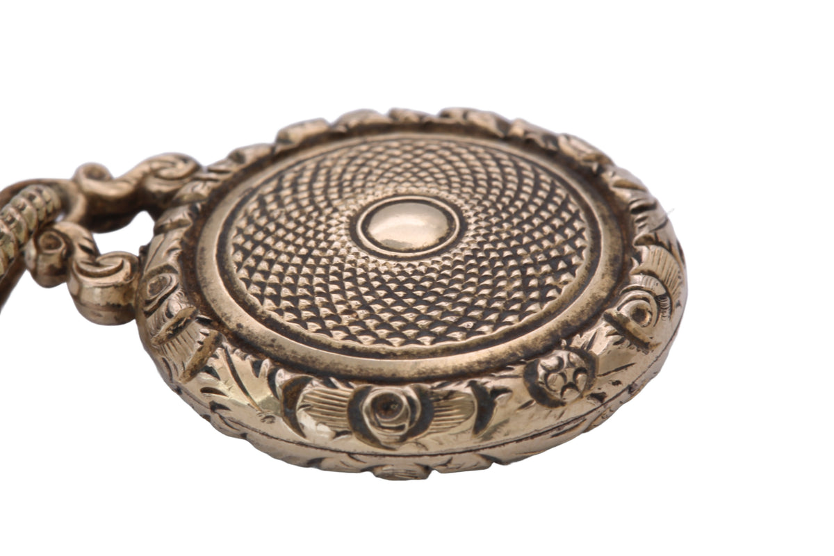 Georgian gold locket showing chased foliate border and textured centre