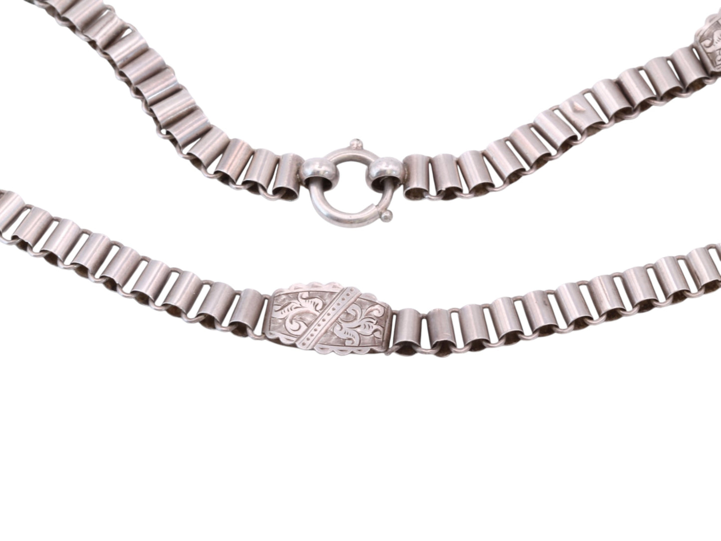 Close-up of antique sterling silver book chain necklace and circular clasp