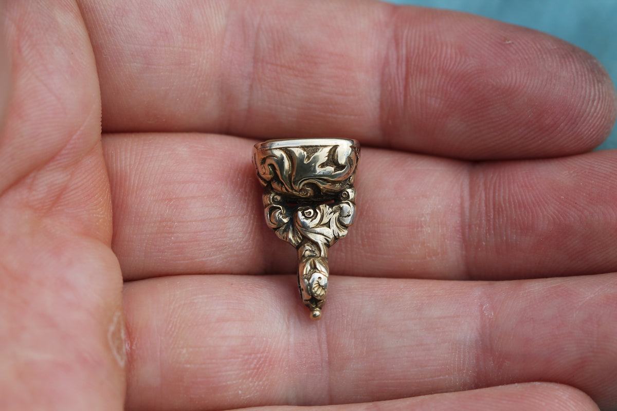 Victorian fob seal showing ornate scrolling gold cased mount