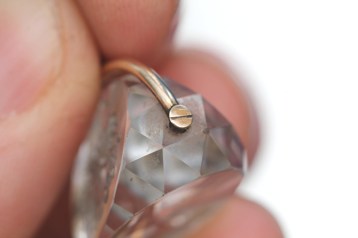 Close-up of heraldic engraving within antique rock crystal spinner fob
