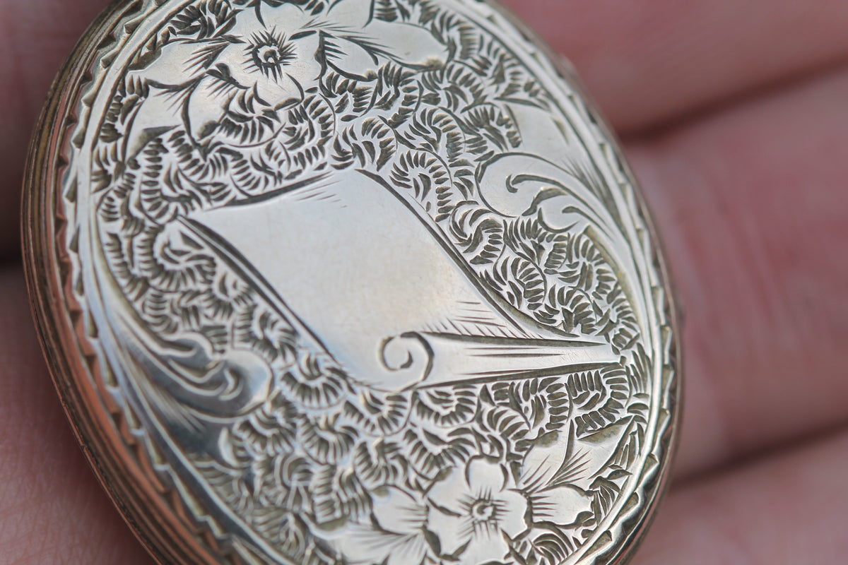 Reverse of Victorian gold locket showing engraved foliate decoration