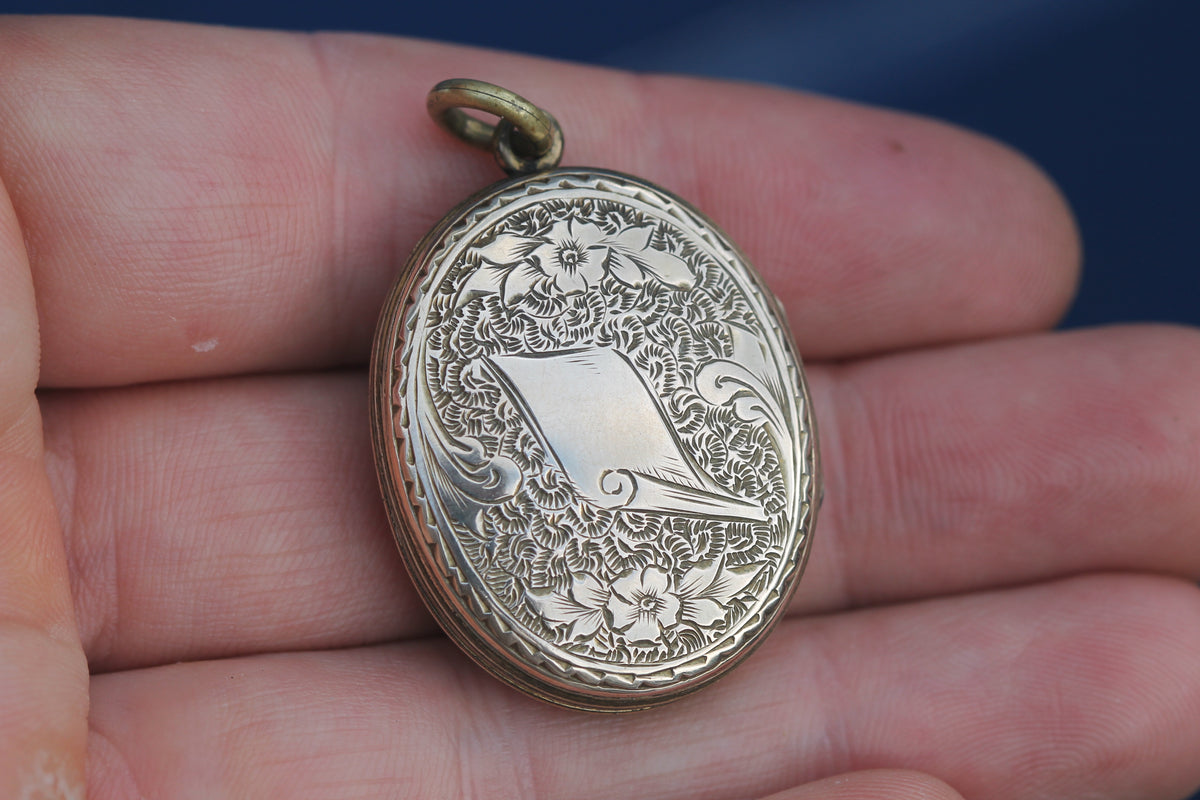 Open antique Victorian locket showing two internal keepsake panels