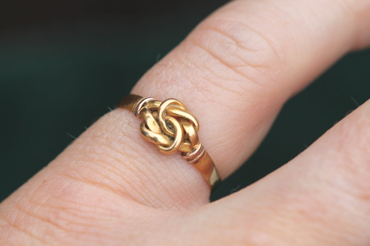 Close-up of Victorian 22ct gold interwoven love knot ring