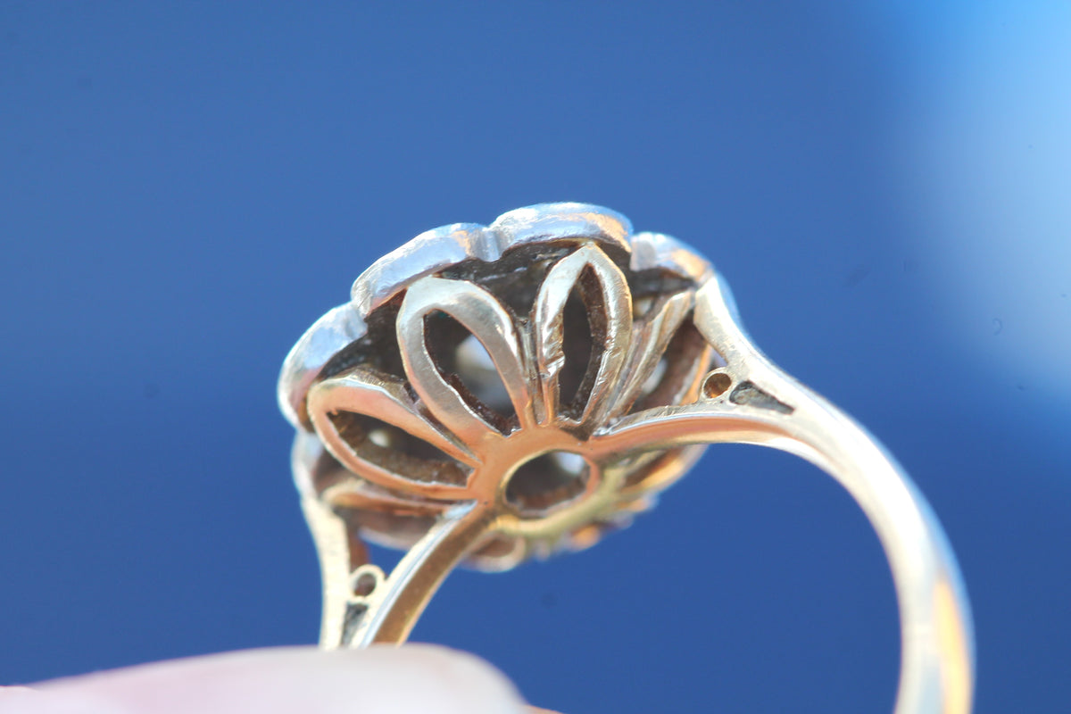 Close-up of nine old mine cut diamonds in flower-shaped cluster
