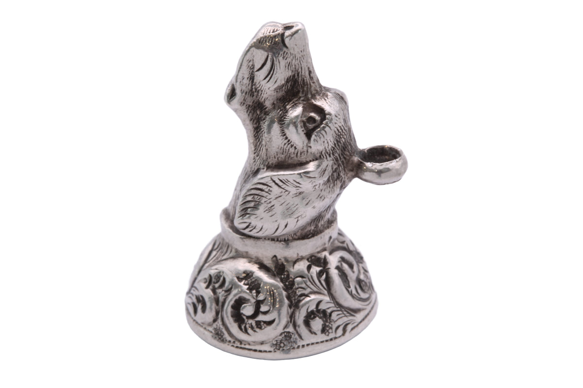 Close-up of sculptural Victorian silver dog head with engraved fur