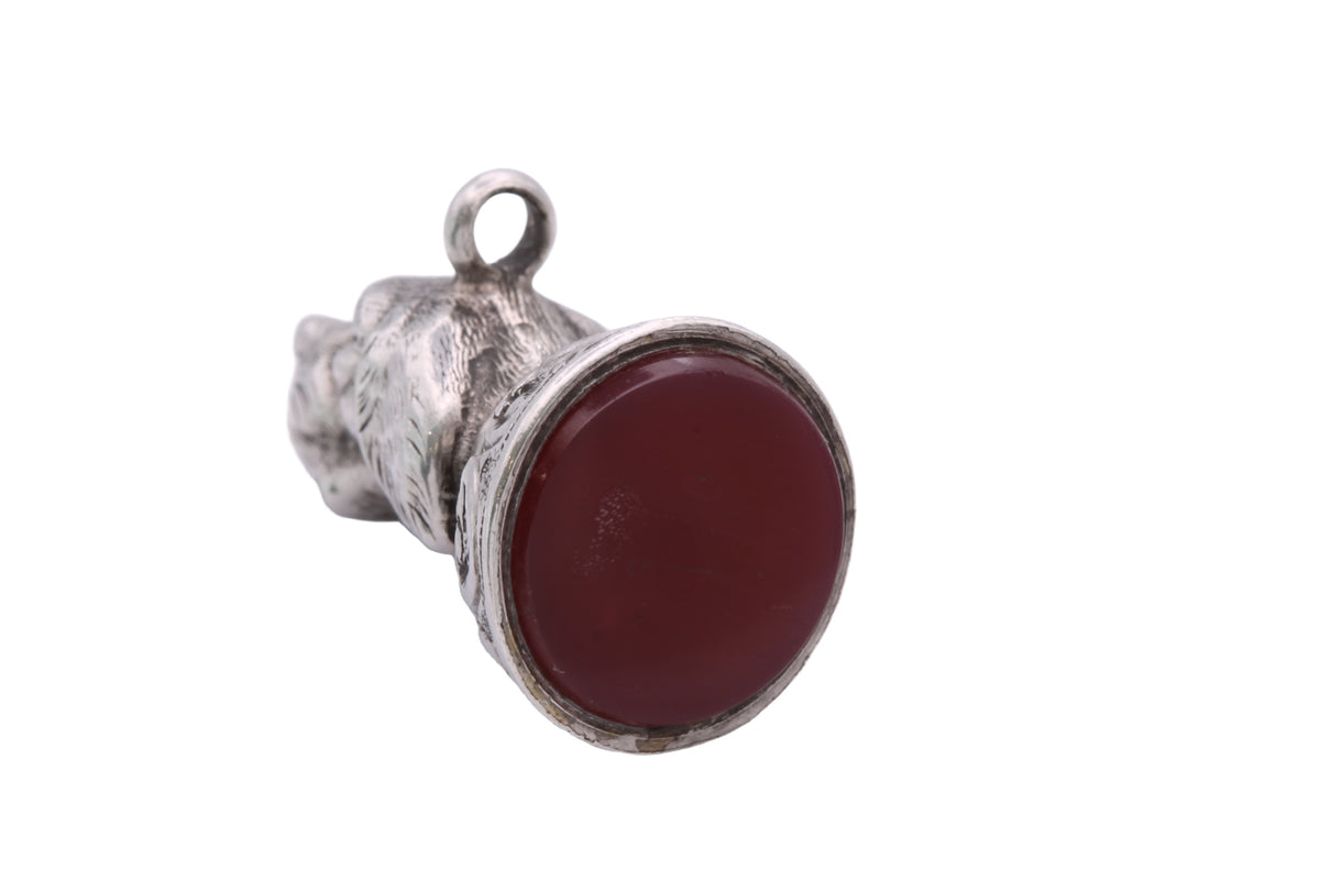Victorian silver dog head seal shown in the hand