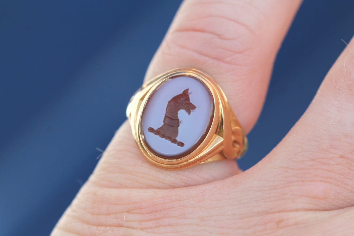 Antique sardonyx dog intaglio signet ring worn on the finger